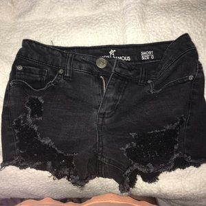 black distressed shorts .